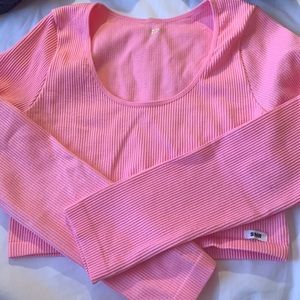 A long sleeve bright pink fitted crop top